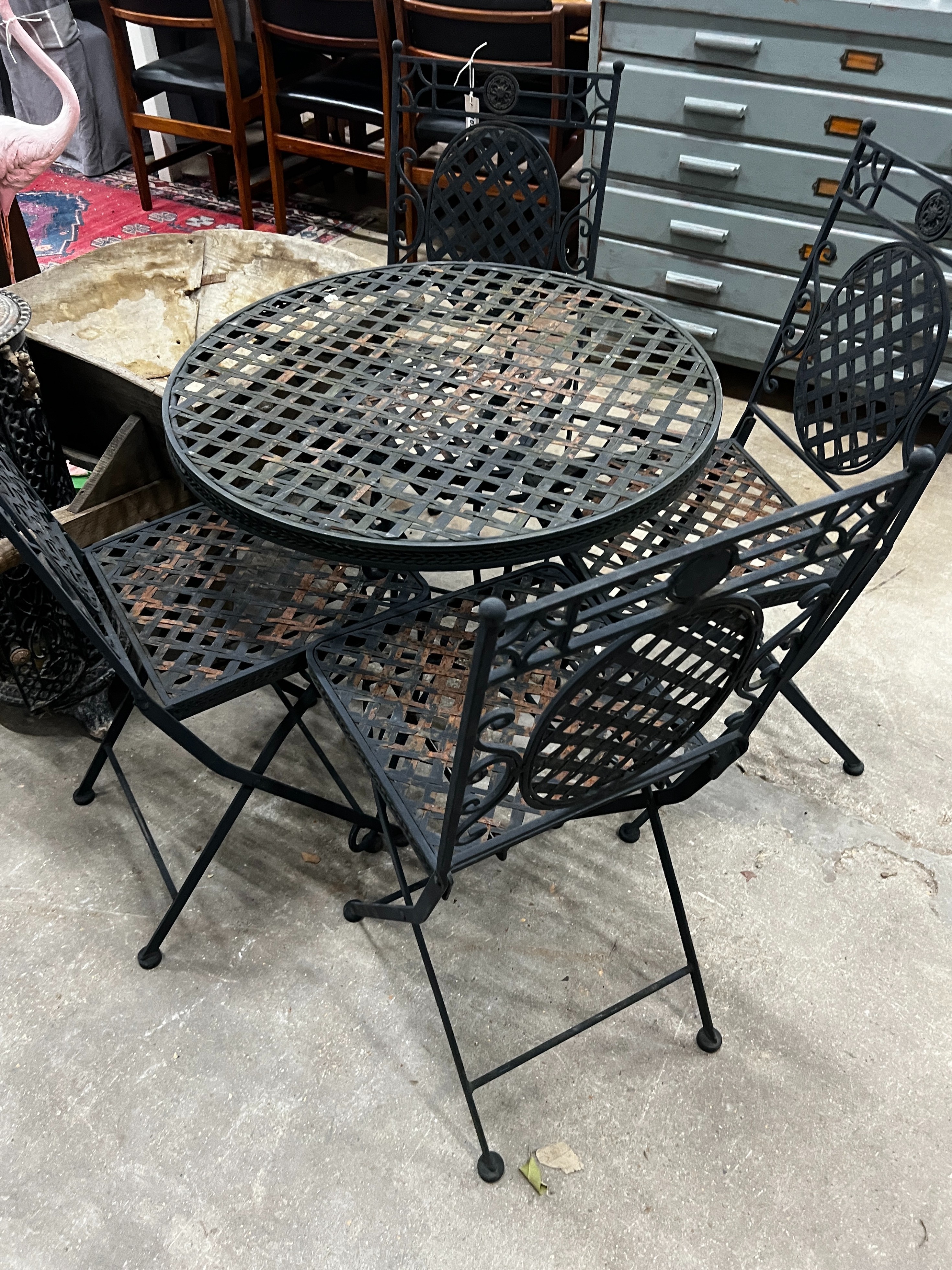 A circular painted metal garden table, diameter 70cm, height 71cm together with four matching folding garden chairs